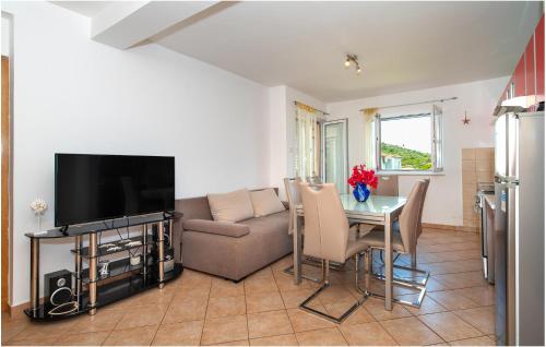 a living room with a couch and a table with a television at Gorgeous Apartment In Razanj With Wifi in Ražanj