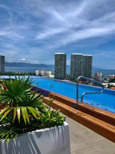 a balcony with a view of a swimming pool at Chic 1BR 1BA Zoho Skies condo with rooftop pool stunning views in Puerto Vallarta