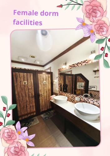 a bathroom with two sinks and a large mirror at DRIMIN - by Sunrise Caravan boutique Guesthouse and hostel in Tashkent