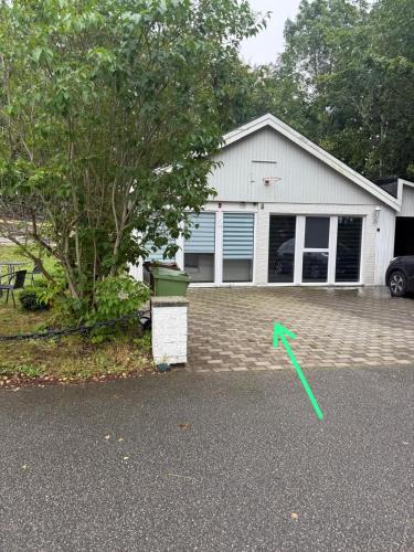 a green frisbee on the ground in front of a house at Guest house in Lyckeby in Karlskrona