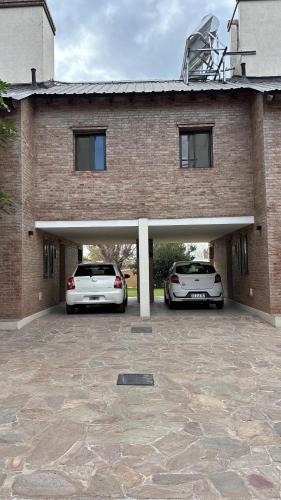 two cars are parked in a garage at Terroir Village - Complejo en Mendoza in Guaymallen