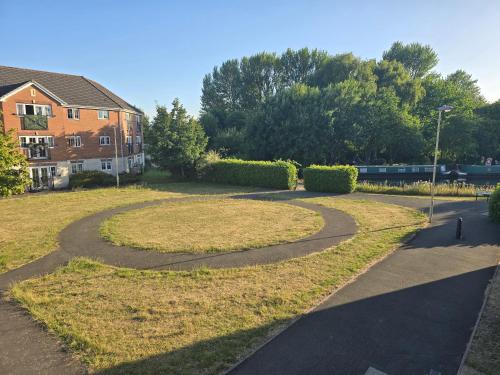 a winding path in a park next to a building at Furnished double room in Rowley Regis