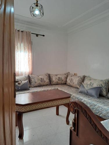 a living room with a couch and a table at Diafa Stay in Tangier