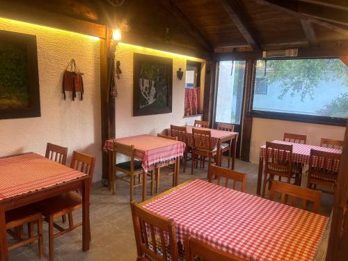 a restaurant with tables and chairs in a room at Apartment Mila in Plitvička Jezera