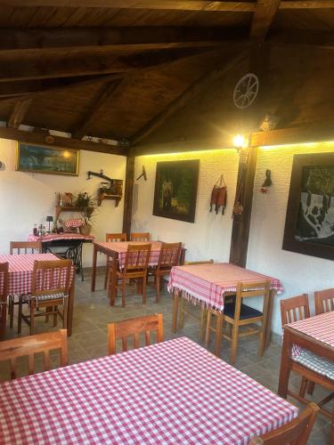 a restaurant with red and white tables and chairs at Apartment Mila in Plitvička Jezera