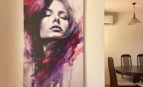 a painting of a woman on a wall in a dining room at BT Lux apartment 2 in Skopje
