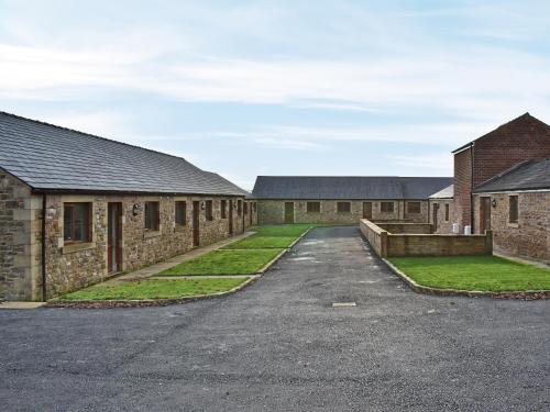 a row of brick buildings with a driveway at Six Dorchester Drive - Uk32627 in Inglewhite