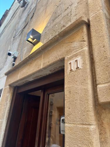 a building with a door with a light above it at la nicchia, relax room & salento stay in Manduria