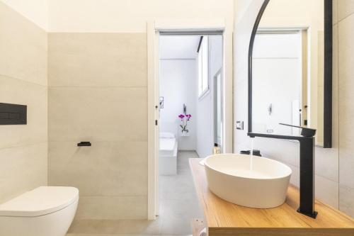 a bathroom with a white tub and a toilet at EnSe Affittacamere in Tortolì
