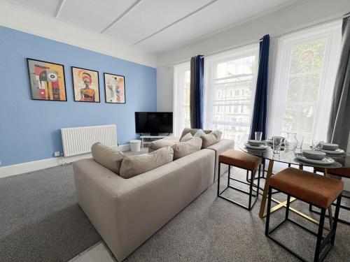 a living room with a white couch and a table at Prime Central London 2-Bed by Shops & Transport in London