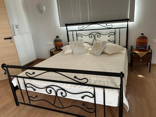 a bedroom with a black and white bed with pillows at Zografos Studios Zacharo Zakharo in Zakharo