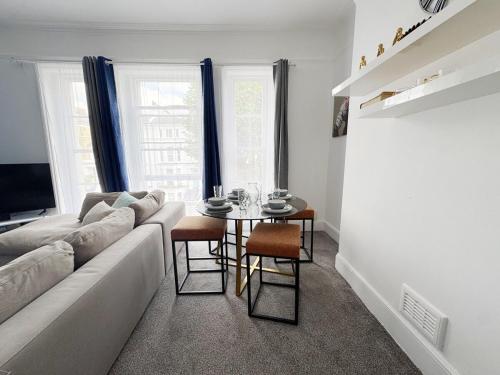 a living room with a couch and a table at Prime Central London 2-Bed by Shops & Transport in London