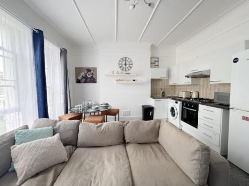a living room with a couch and a kitchen at Prime Central London 2-Bed by Shops & Transport in London