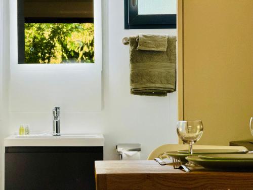 a kitchen with a table with a sink and a window at Domaine du Mafay - LODGE BROCÉLIANDE in Bourg-des-Comptes