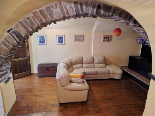 a living room with a couch in an archway at Antico Arco in Montalto Ligure