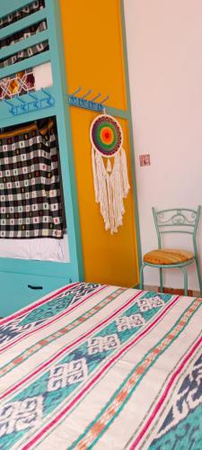 a bedroom with a bed and a colorful wall at Riad SULTANA lateral seaview in Saidia 