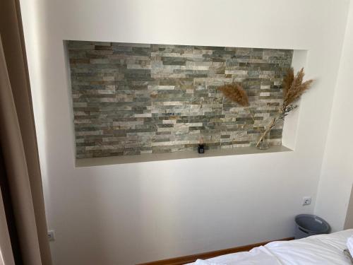 a painting of a brick wall in a bedroom at Apartment Dubravko mit Meerblick 100 m Strand, Parking in Maslenica
