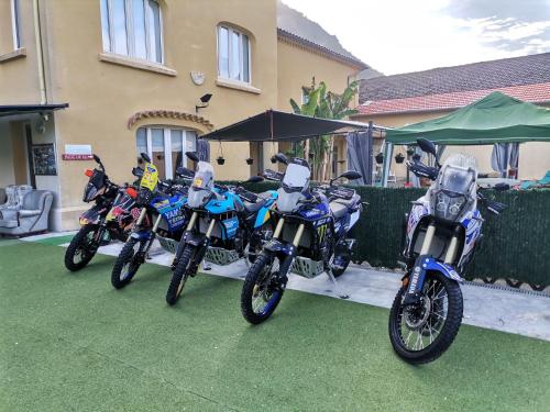 three motorcycles parked in front of a house at Hotel Restaurant Rose des Pyrénées in Belvianes-et-Cavirac