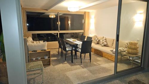 a living room with a table and a couch at Villa vue mer imprenable- charme et tranquillité in Sidi Boulfdail