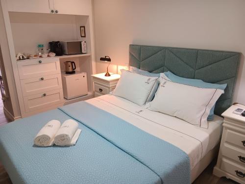 a bedroom with a bed with two slippers on it at Casa d'Artengo in Ponte de Lima