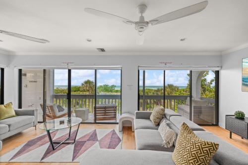 a living room with a couch and a table at Just Beachy By Beachside Management in Siesta Key