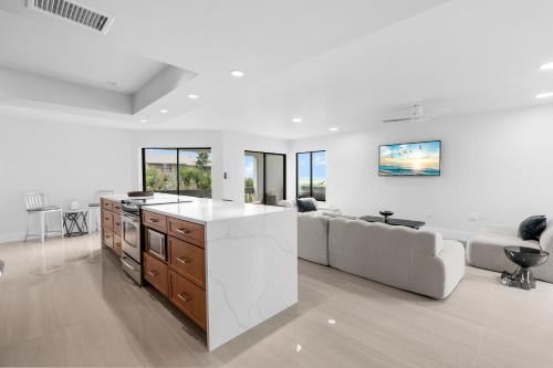 a kitchen and living room with a couch and a table at Just Beachy By Beachside Management in Siesta Key