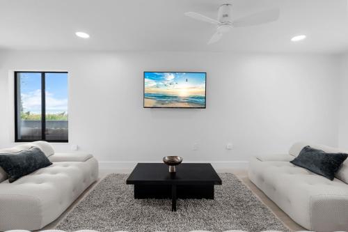 a living room with two couches and a coffee table at Just Beachy By Beachside Management in Siesta Key