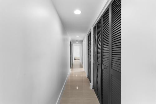 a corridor of black lockers in a white hallway at Just Beachy By Beachside Management in Siesta Key