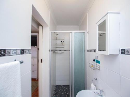 a bathroom with a shower and a sink at Eikelower Accommodation in Stellenbosch