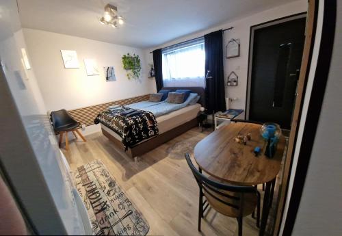 a bedroom with a bed and a table in a room at Akranes 4you - Linda's House in Akranes