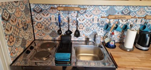 a kitchen counter with a sink and a stove at Akranes 4you - Linda's House in Akranes