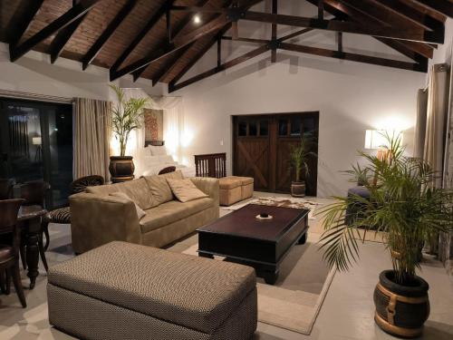 a living room with a couch and a table at Vaal River Royal Mafube Luxury Tented Lodge in Vosburg