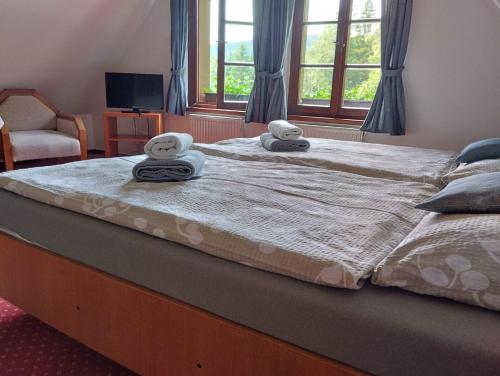 a large bed with two stuffed animals on top of it at Pension U Háčků in Harrachov
