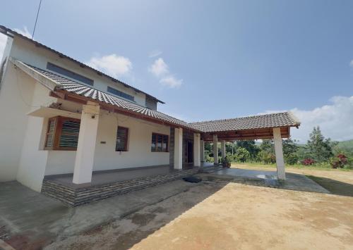 a small house with a porch at Thotadagadde Homestay in Mudigere