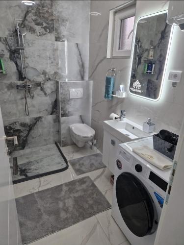 a bathroom with a toilet and a sink and a shower at Villa Dunja Prijedor in Prijedor