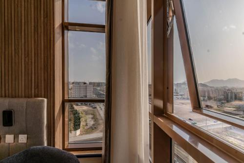 a room with a window with a view of a city at فندق هيل Hill Hotel in Al Madinah