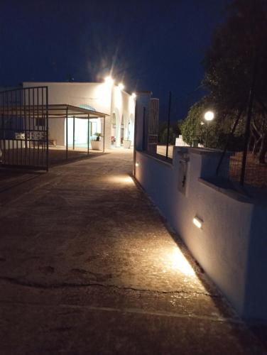 a building with lights on the side of it at night at Villa Nenetta in Ostuni