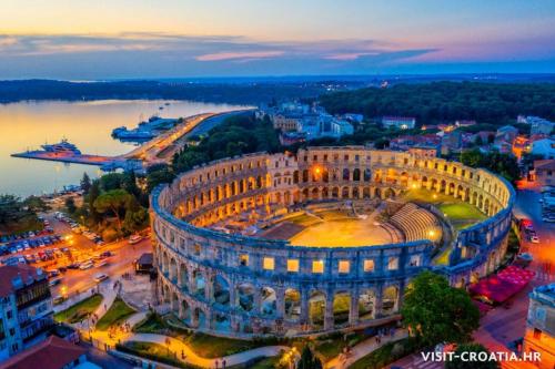 an aerial view of a building in a city at night at App Damiani in Oprtalj