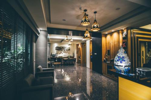 a room with a lobby with a table and chairs at Mambo Boutique Hotel in Hengchun