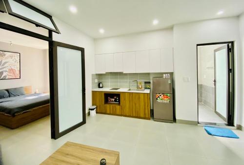 a kitchen and a living room with a refrigerator at HPT Home II Vinhome Marina chuỗi Apartment - Homestay in Hai Phong