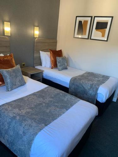 a hotel room with two beds at The Tontine Hotel in Greenock