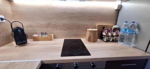 a counter in a refrigerator with a phone and water bottles at Βalcony View Μarmaras in Neos Marmaras