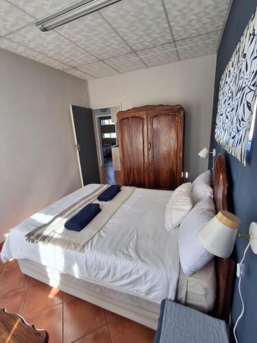a bedroom with a large bed with a wooden headboard at The Loft in Bloemfontein