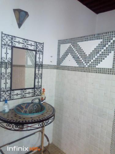 a bathroom with a sink and a mirror at Riad Kasbah in Rabat