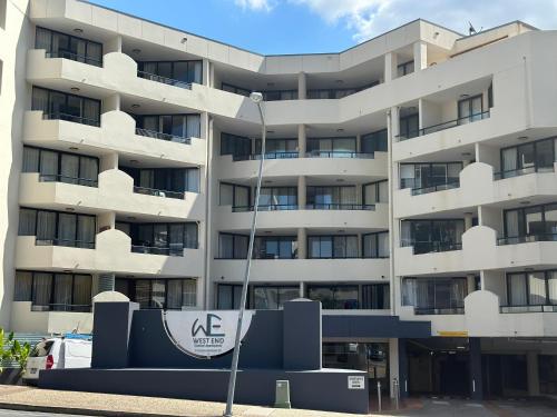 an apartment building with a kz sign in front of it at Beautiful Hotel Rooms Free Parking in Brisbane