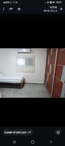 a picture of a room with a bed and a radiator at הבית של רביבו in Sderot