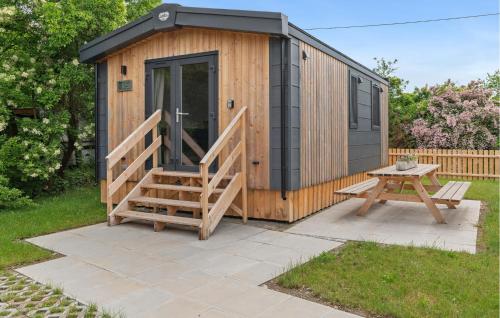 a small wooden cabin with a bench and a table at Gorgeous Home In Erkheim With Wifi in Erkheim