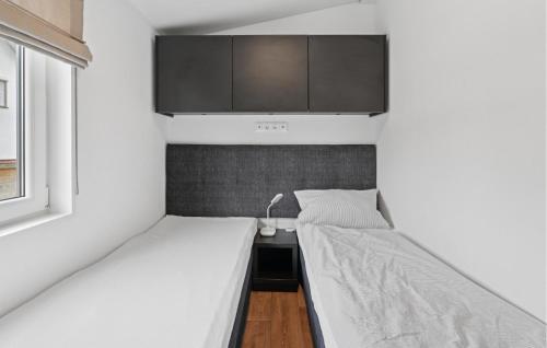 a small bedroom with two beds and a cabinet at Gorgeous Home In Erkheim With Wifi in Erkheim