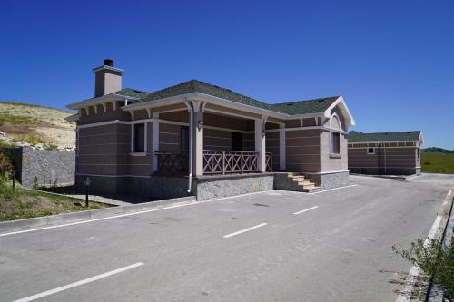 a house on a street with a road at Green Village HOTEL & SPA in Sis