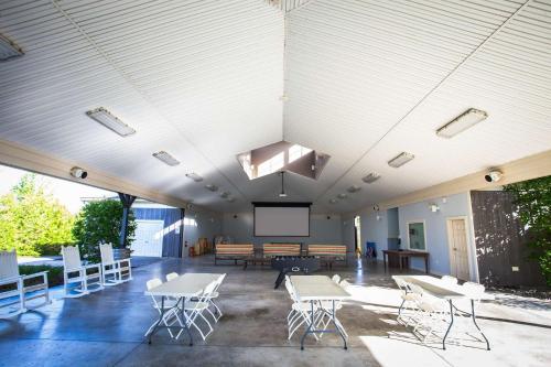 a large room with tables and chairs and a projection screen at The Lynx - 35 Butternut in Cherry Valley